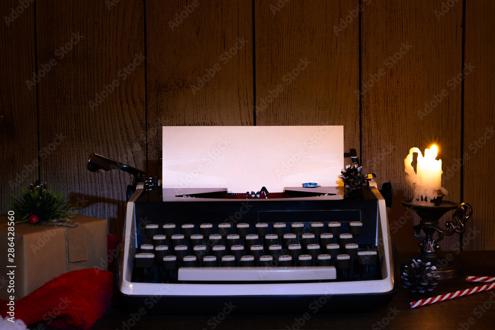 Fototapete retro typewriter with a blank sheet of paper for text. dark christmas and new year background. mock 