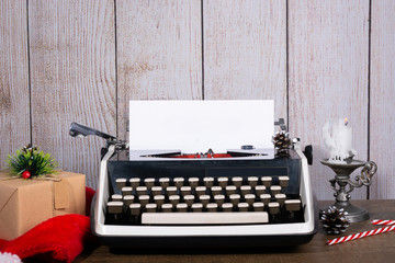 Retro typewriter with a blank sheet of paper for text. New Year and Christmas background Mock up, Copy space.
