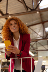 Curly woman standing and enjoying little break from work