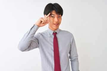 Chinese businessman wearing elegant tie standing over isolated white background Smiling pointing to head with one finger, great idea or thought, good memory