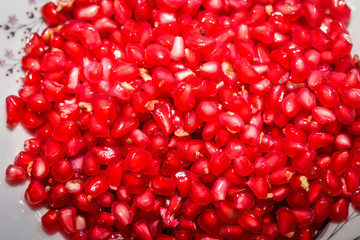 Red ripe pomegranate seeds closeup. health food. beautiful background texture of the seeds of the pomegranate. Wallpaper design.Pomegranate seeds with vivid colors
