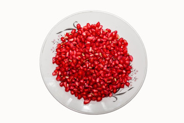 Ripe pomegranate fruit segment isolated on white background cutout. Close-up image of pomegranate seeds