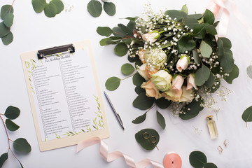 Checklist with main items, roses bouquet and golden rings