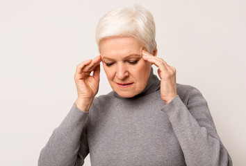 Depressed Senior Woman Touching Temples, Having Headache