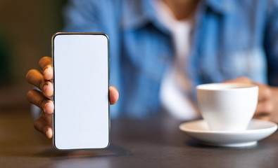 Man showing mobile smartphone with blank screen