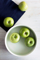 Green color apples on table
