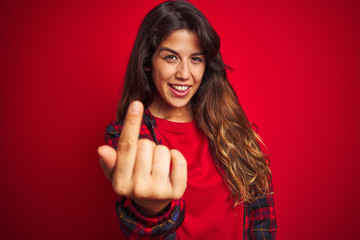 Young beautiful woman wearing casual jacket standing over red isolated background confused and annoyed with open palm showing copy space and pointing finger to forehead. Think about it.