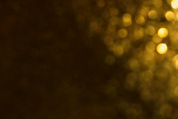 background of abstract glitter lights. gold and black. de focused