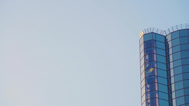 Glass Elevator Going Up the Glazed Facade of Skyscraper. Glass Curtain Facade Wall Background.