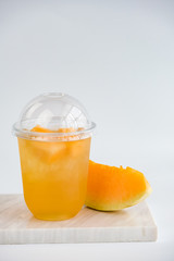 Fruit tea cups. Iced tea melon on rustic white marble table. 