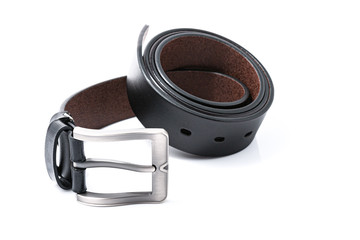 Black men's leather belts men's elegance trend on round shape with a white background. Fashion concept.