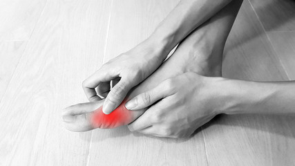 Foot anatomy with red highlight on painful area.  Toe pain may cause from bone fracture,...