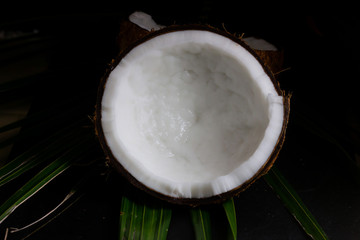 Coconut cut half isolate on black background