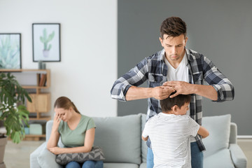 Obraz premium Little boy hugging his father who is taking off wedding ring. Concept of divorce