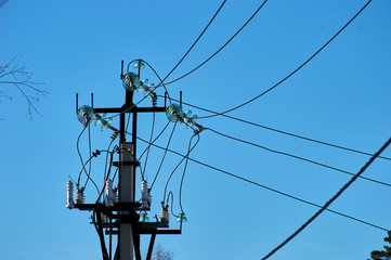 electric power wires and glass caps on the top of the long industrial pole