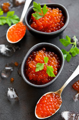 Red caviar on a black background