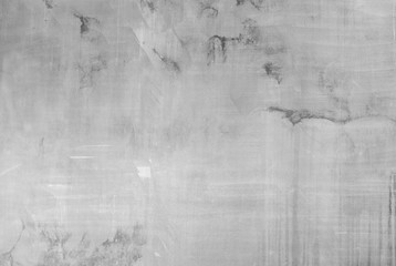 High resolution full frame background of a faded, dirty and gray concrete wall in black and white....