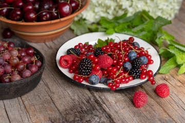 Berries in bowls on a rough wooden table