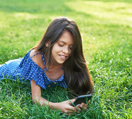 child girl with phone in the park