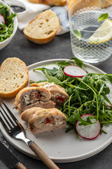 Roasted chicken breasts stuffed with mushrooms, green onion, pepper and garnished fresh salad and rocket salad.