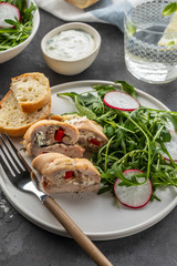 Roasted chicken breasts stuffed with mushrooms, green onion, pepper and garnished fresh salad and rocket salad.