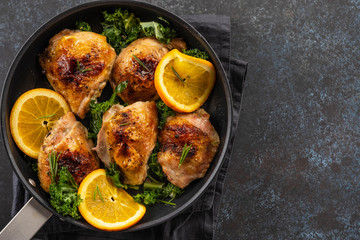 Pieces of chicken baked with oranges and red pepper.