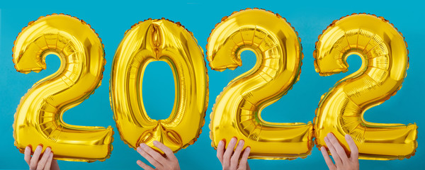Gold foil number two thousand and twenty two 2022 celebration balloon on blue background