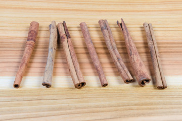 Dried cinnamon sticks on the wooden surface