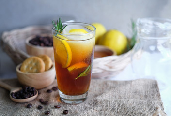 Americano iced coffee with lemon and rosemary for healthy drinking 