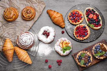 Assortment of sweet pastry on grey background