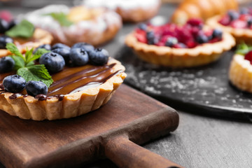 Sweet tartlet on wooden board, closeup