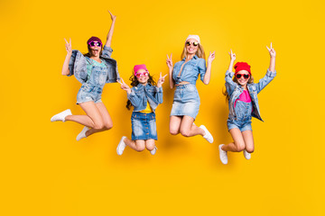 Fototapeta na wymiar Summer time concept. Full length photo of four excited crazy funny funky trendy making giving t-sign wearing streetstyle denim apparel skirt overall having good mood isolated bright yellow background