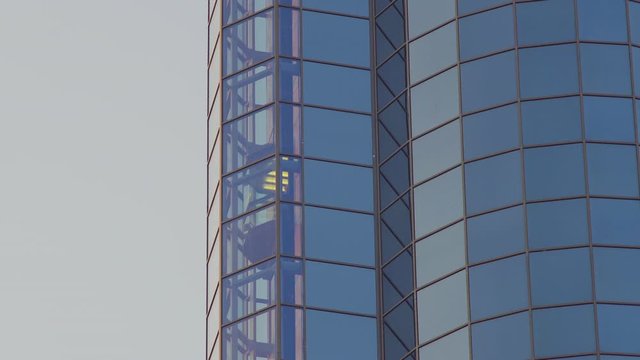 Glass Elevator Going Up the Glazed Facade of Skyscraper. Glass Curtain Facade Wall Background.