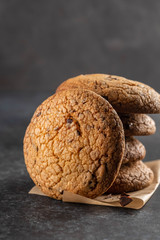 Chocolate cookies on grey table. Chocolate chip cookies shot. Homemade food on grey background.