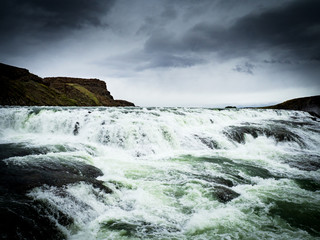 Gullfoss waterfall with dark clouds in Iceland