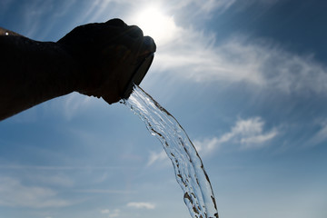 Metallic mug and flowing water.