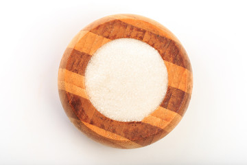 Sugar in wooden  bowl isolated on white background  top view