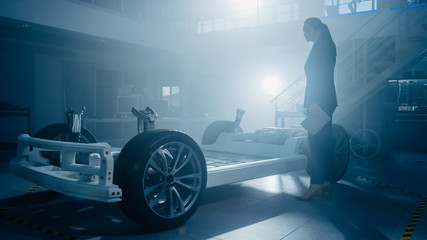Silhouette of a Female Automobile Design Engineer in Automotive Innovation Facility Working on...