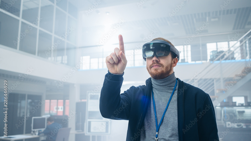 Leinwandbilder Automotive Engineer Using Augmented Reality Headset and Making Touching Gestures of Virtual Objects in the Air. In Innovation High Tech Laboratory Facility with Futuristic Atmosphere.