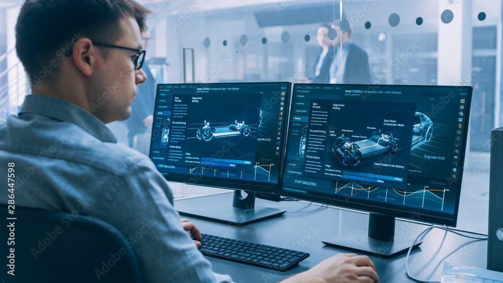 Poster professional engineer works on a computer with a 3d cad software and tests the electric car chassis 
