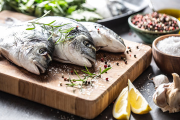 Mediterranean fish bream with spices salt herbs garlic and lemon. Healthy seafood. Concept of healthy sea food