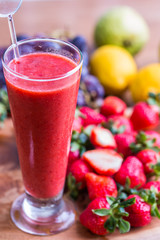 Fresh delicious strawberry juice drink with dark red color in a tall glass