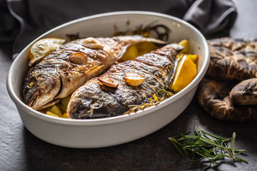 Roasted mediterranean fish bream with potatoes rosemary and lemon