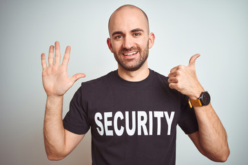 Young safeguard man wearing security uniform over isolated background showing and pointing up with...