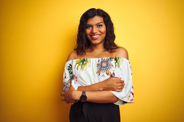 Transsexual transgender woman wearing summer t-shirt over isolated yellow background happy face smiling with crossed arms looking at the camera. Positive person.