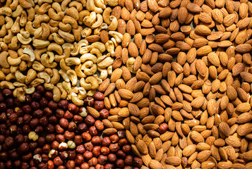 Nuts baked - almond, cashew, hazelnut in sun light, top view, healthy diet