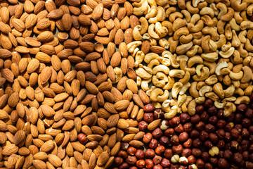 Nuts baked - almond, cashew, hazelnut in sun light, top view, healthy diet