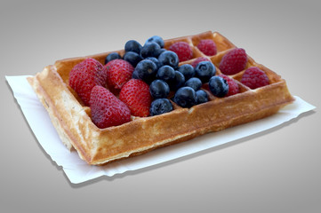 Waffle with fruits - strawberries, blueberries and raspberries