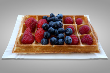 Waffle with fruits - strawberries, blueberries and raspberries