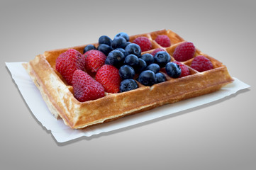 Waffle with fruits - strawberries, blueberries and raspberries